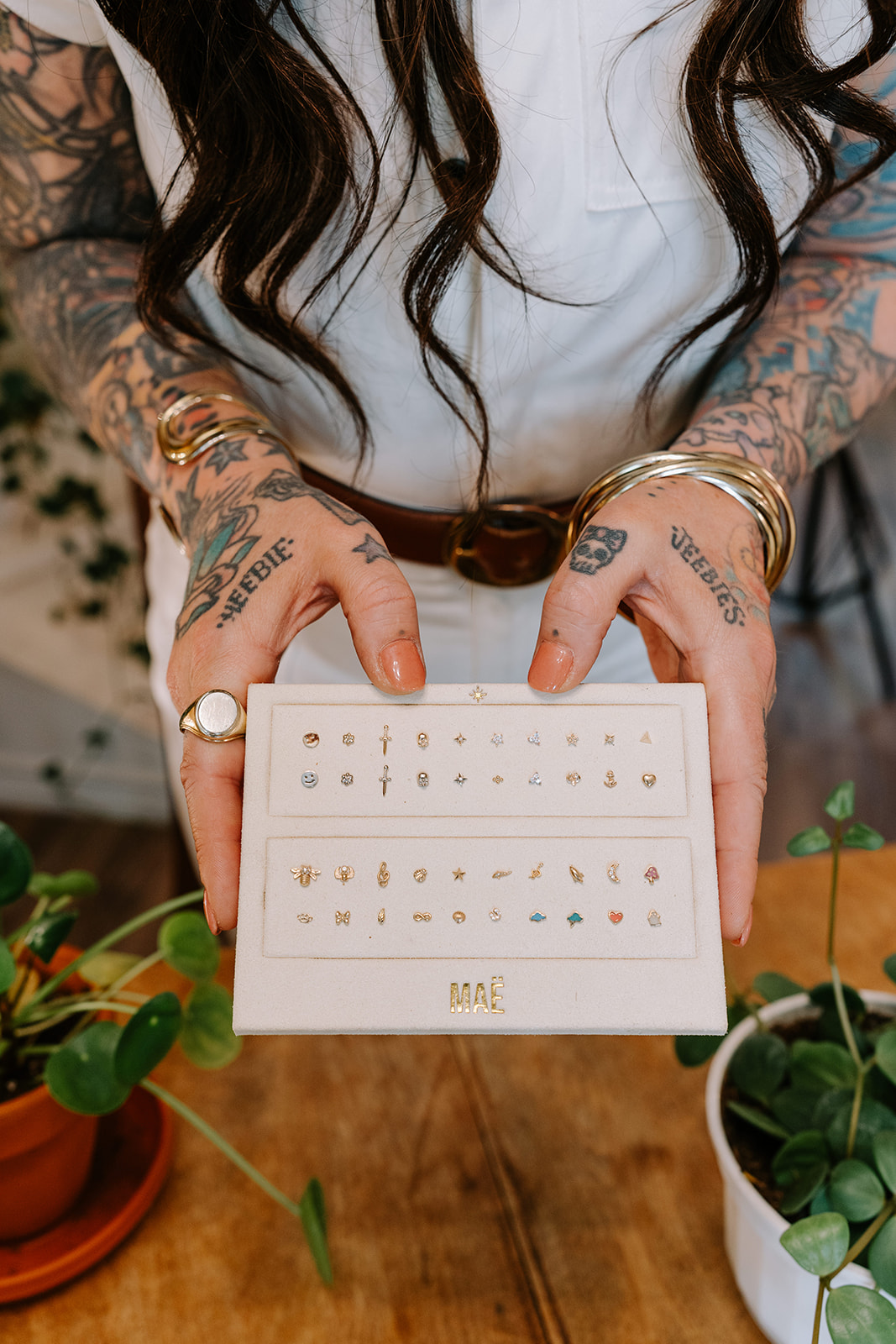 Tray of curated titanium and gold piercing jewelry