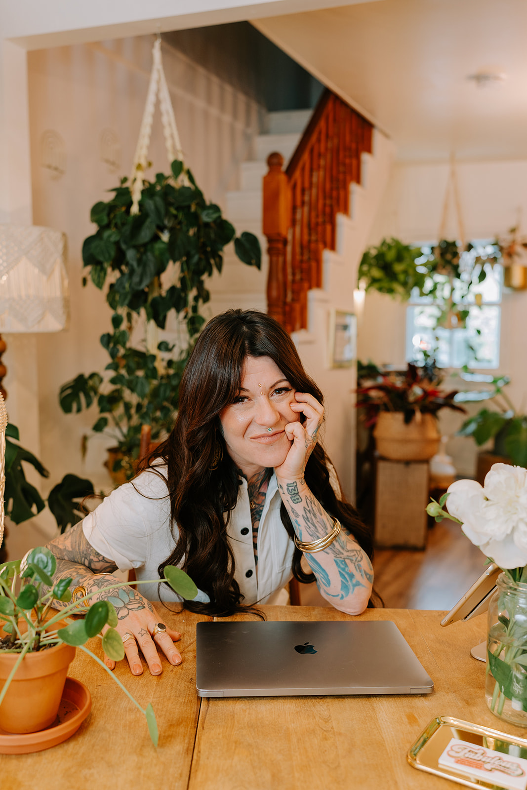 Juliette at the studio desk surrounded by plants